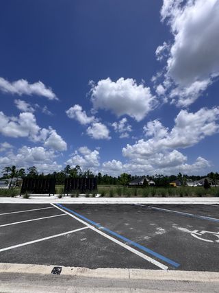 Expansive sky over a community with a parking lot in Hyland Trail by Pulte Homes, Green Cove Springs, FL.