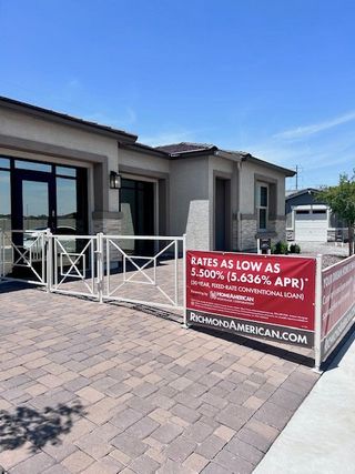 A modern home with a paved walkway in Estates at Laveen Vistas by Richmond American Homes (Laveen, AZ).