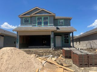 Street view A beautiful two-story home under construction in Monarch at the Meadows by D.R. Horton (Denton, TX).