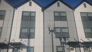 A sleek, modern townhome development with large windows and private balconies in Johnson Commons by Breeze Homes (Jacksonville, FL).