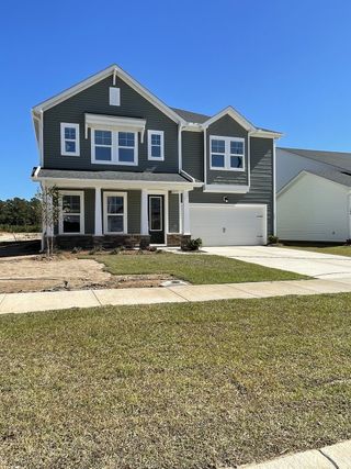 A charming gray two-story home with white trim in The Groves of Berkeley by Beazer Homes, Moncks Corner, SC.