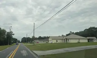A spacious home with a manicured lawn in the Inverness community by Maronda Homes (Inverness, FL).