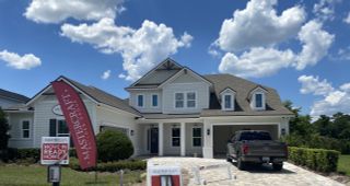 A beautiful modern home with a gabled roof and a tidy driveway in SilverLeaf by MasterCraft Builder Group (St. Augustine, FL).