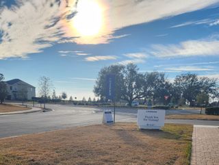 A scenic entrance view in Edenbrooke at Hyland Trail by Lennar, Green Cove Springs, FL, with expansive skies and tranquil roads.