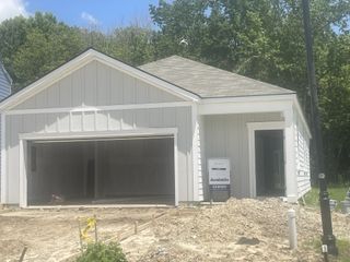 Charming new white home with a double garage in The Oaks at Center Station by D.R. Horton (Hollywood, SC).