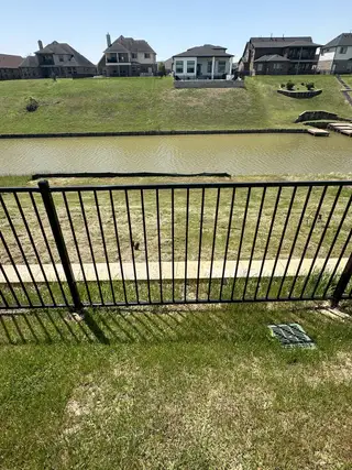 Street view Scenic waterfront view with modern homes in Waterstone on Lake Conroe by K. Hovnanian® Homes (Montgomery, TX).