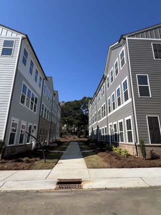 Modern townhomes with gray siding and landscaped paths in Galloway Towns by Pulte Homes (Charlotte, NC).