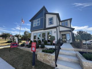 A modern two-story home with manicured landscaping in Sarah's Creek by Taylor Morrison (Pflugerville, TX).