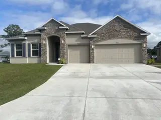 A beautiful stone-accented home with a spacious driveway in Palm Bay by Maronda Homes (Palm Bay, FL).