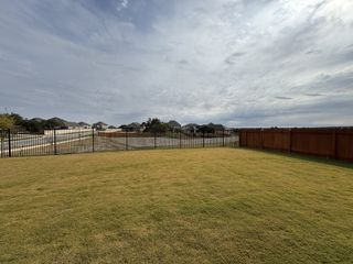 Model Home A sprawling fenced yard with expansive views in Heights at San Gabriel by GFO Home (Georgetown, TX).