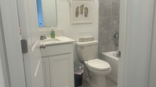 A modern bathroom with sleek fixtures, tiled walls, and minimalistic decor for a clean, fresh look.