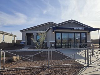 A modern desert-inspired home with a sleek fence in Avanti at Granite Vista by Elliott Homes (Waddell, AZ).