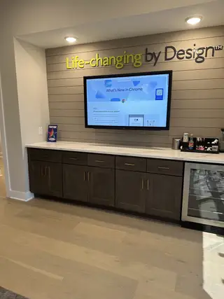 A modern media nook with a sleek TV, dark wood cabinetry, and stylish lighting. Perfect for entertainment and relaxation.