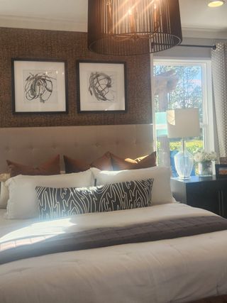 A cozy bedroom with abstract artwork, textured walls, a plush bed, and elegant lighting for a modern touch.