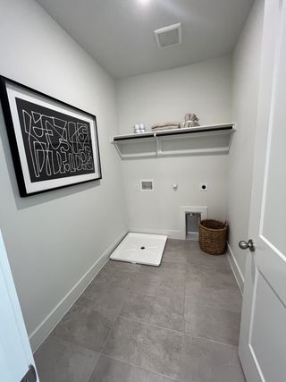 Model Home A spacious walk-in closet with shelving and hanging rods for organized storage.