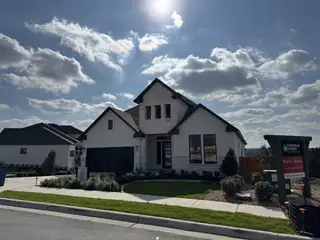 A beautiful modern home with sleek design and lush landscaping in Sweetwater by Chesmar Homes (Austin, TX).