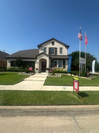 A beautiful brick home with manicured lawns in Lake Pointe by Beazer Homes (Little Elm, TX).