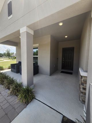 Elegant covered entry with seating area at Marion Creek by Taylor Morrison in Haines City, FL.