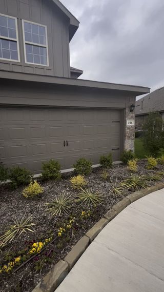 Lovely home with a sleek garage and manicured landscaping in Winchester Crossing by D.R. Horton (Princeton, TX).