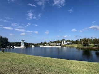 Community Amenities A serene lakeside view in RiverTown - Bluffs by Mattamy Homes, showcasing lush greenery and tranquil waterscape (St. Johns, FL).