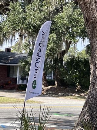 A charming home with lush trees and a vibrant yard in Bermuda Pointe Towns by Prosperity Builders (Charleston, SC).