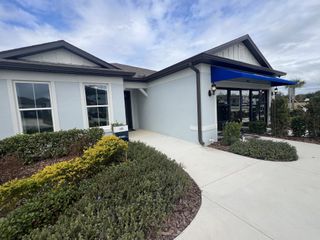 Street view A charming front view with manicured landscaping and a welcoming entryway in Silverlake by Pulte Homes (Lake Alfred, FL).