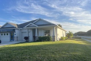 A charming home with a lush yard in the Lakes At St Sebastian by Holiday Builders (Micco, FL).