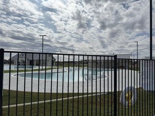 Community Amenities A modern community pool area in Santa Rita Ranch: 90ft. lots by Highland Homes, showcasing leisure and style (Liberty Hill, TX).