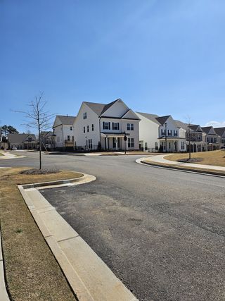Charming white homes with spacious yards in Brackley Single Family by The Providence Group, Cumming, GA.
