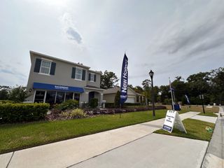 A modern two-story home with charming shutters in Pelham Park by D.R. Horton, Deland, FL. Welcoming lawn and signage.