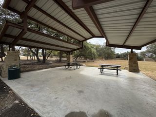 Community Amenities A covered picnic pavilion with sturdy stone columns offers a shaded retreat for gatherings in Lakeside at Lake Georgetown by Coventry Homes (Georgetown, TX).