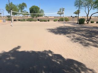 A sandy volleyball court nestled among trees in Magnolia at Desert Passage by KB Home (Maricopa, AZ).