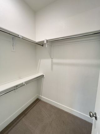 A spacious walk-in closet with stylish shelving and ample hanging space, offering organized storage solutions.