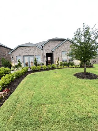 A charming brick home with landscaped yard in Madera by D.R. Horton, Royse City, TX.