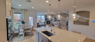 A charming dining area beside a cozy living space, with large windows offering natural light.