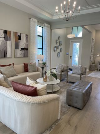 A chic living room with modern art, elegant seating, subtle lighting, and stylish decor accents.