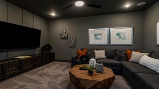 A cozy media room featuring a large sectional sofa, artwork, and a wood coffee table, perfect for entertainment.