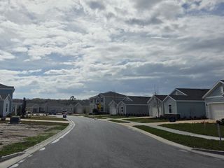 Street view Charming street view of modern homes under a partly cloudy sky in Trailmark by Lennar (St. Augustine, FL).