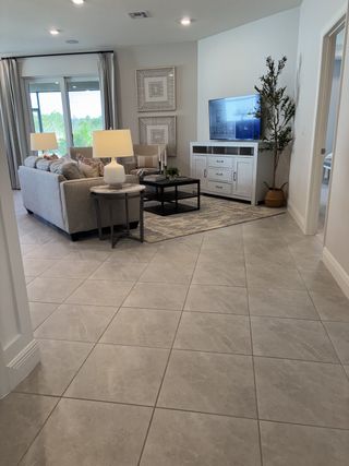 A contemporary living room featuring cozy seating, stylish decor, and large windows overlooking a scenic view.