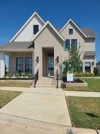 A beautiful modern brick home with a manicured lawn in Hazelwood by Normandy Homes (Frisco, TX).