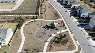 Aerial view of a serene park with playground in Reserve at North Fork by Pulte Homes, Leander, TX.