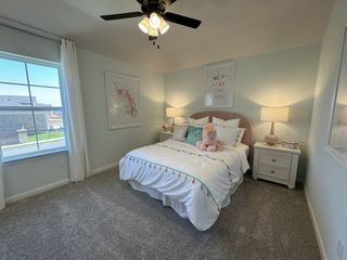 A cozy bedroom featuring soft carpet, playful unicorn decor, and gentle lighting, perfect for a serene retreat.