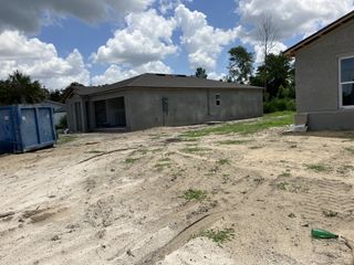 Street view A modern stucco home under construction in Spring Hill Classic by Century Complete (Spring Hill, FL).