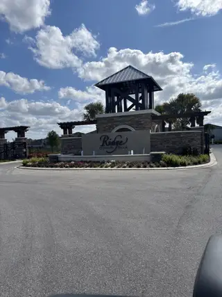 Street view A welcoming entrance with landscaped features at Ridge at Heath Brook by D.R. Horton (Ocala, FL).