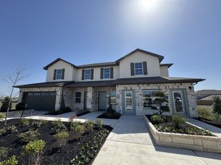 A beautiful two-story home with a landscaped front yard in Palomino by D.R. Horton (Manor, TX).