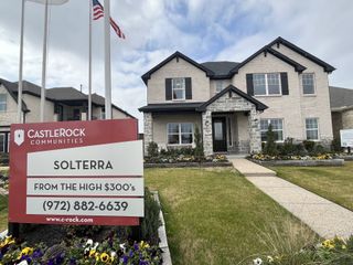 A beautiful model home in the Solterra community with a red information sign.