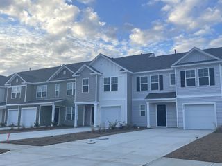 Charming modern townhomes with spacious driveways in Pine Hills Townhomes at Cane Bay by D.R. Horton (Summerville, SC).