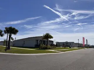 A beautiful suburban street with a spacious lawn in Sunset Lakes Estates by Stanley Martin Homes (Mascotte, FL).