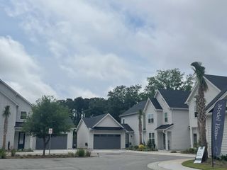 Street view Charming homes with gray siding and palm trees in Hayes Park by New Leaf Builders, Johns Island, SC.
