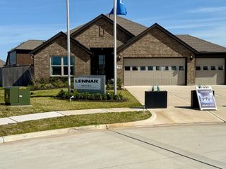 A charming brick home with a manicured lawn in Samara by Lennar (League City, TX), offering modern design and curb appeal.